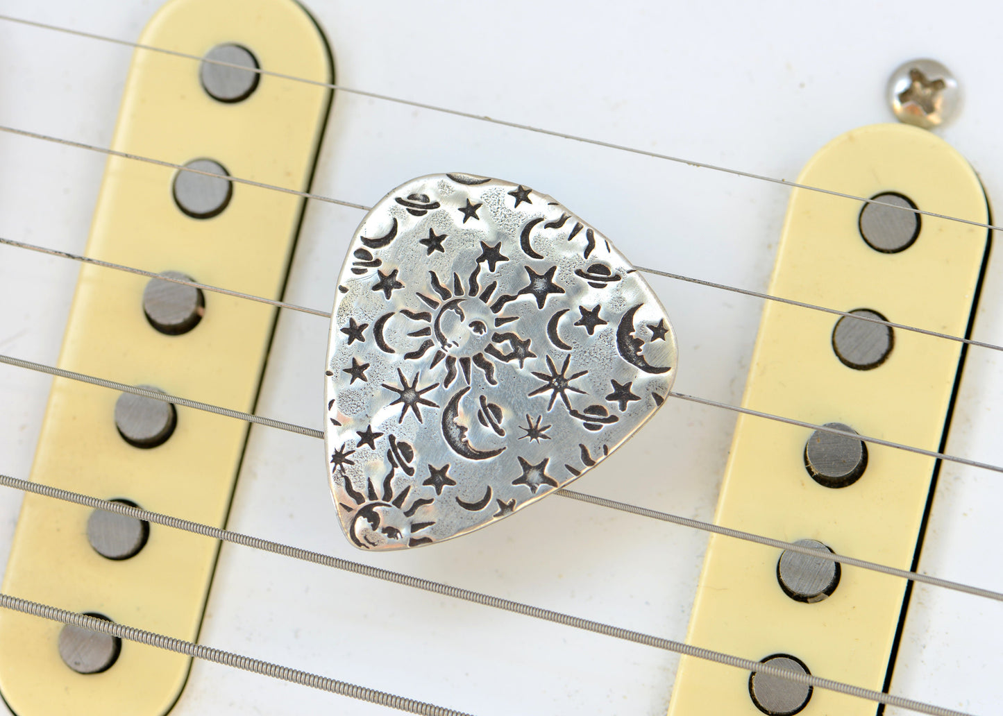 Guitar Pick in Sterling Silver imprinted with Sun Stars and Moon