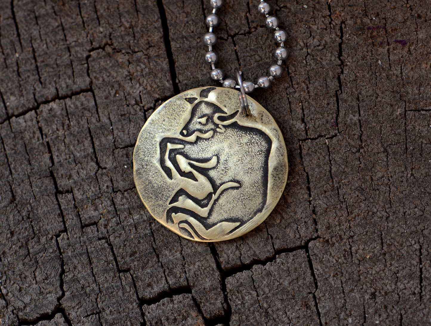 Taurus Zodiac on a brass disc necklace