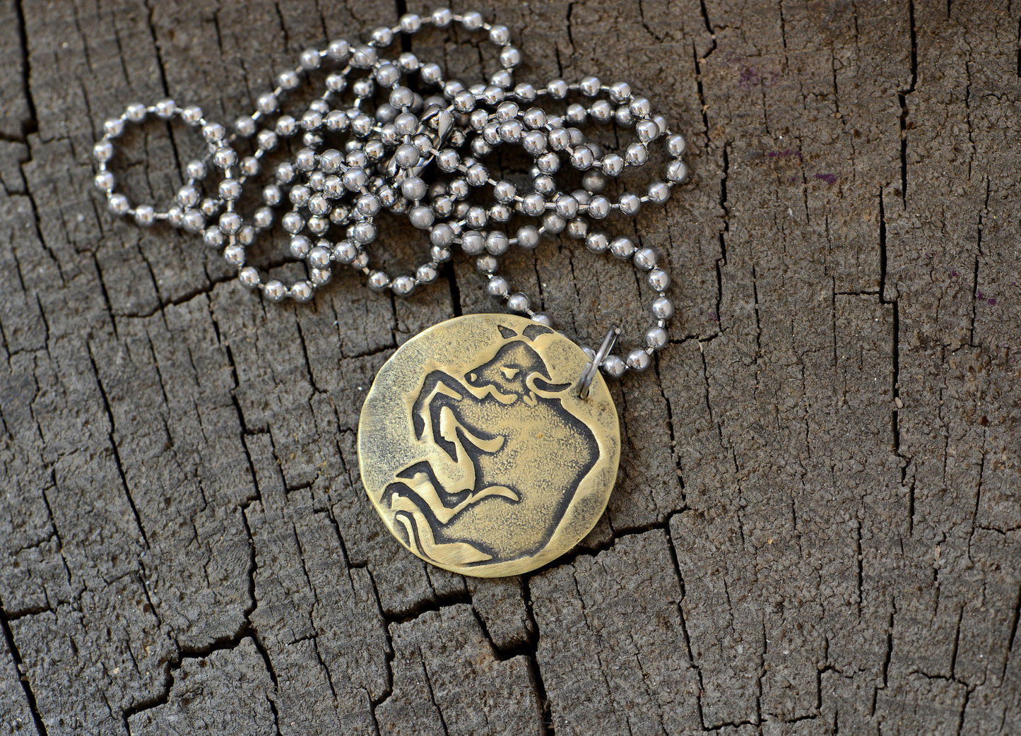 Taurus Zodiac on a brass disc necklace