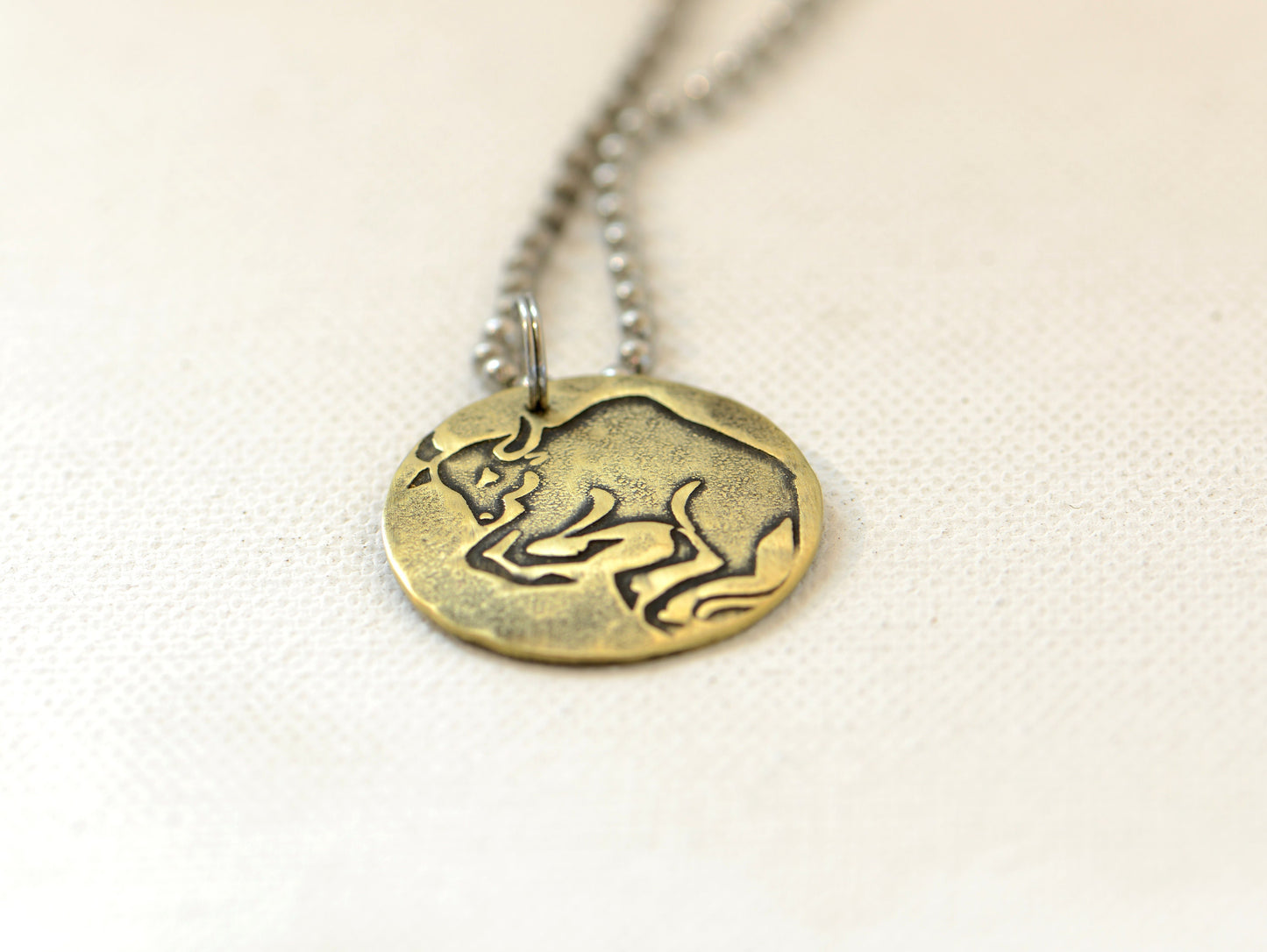 Taurus Zodiac on a brass disc necklace