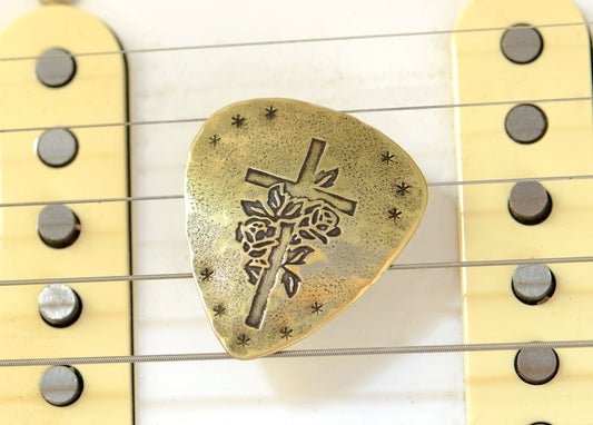 Playable brass guitar pick with cross and roses