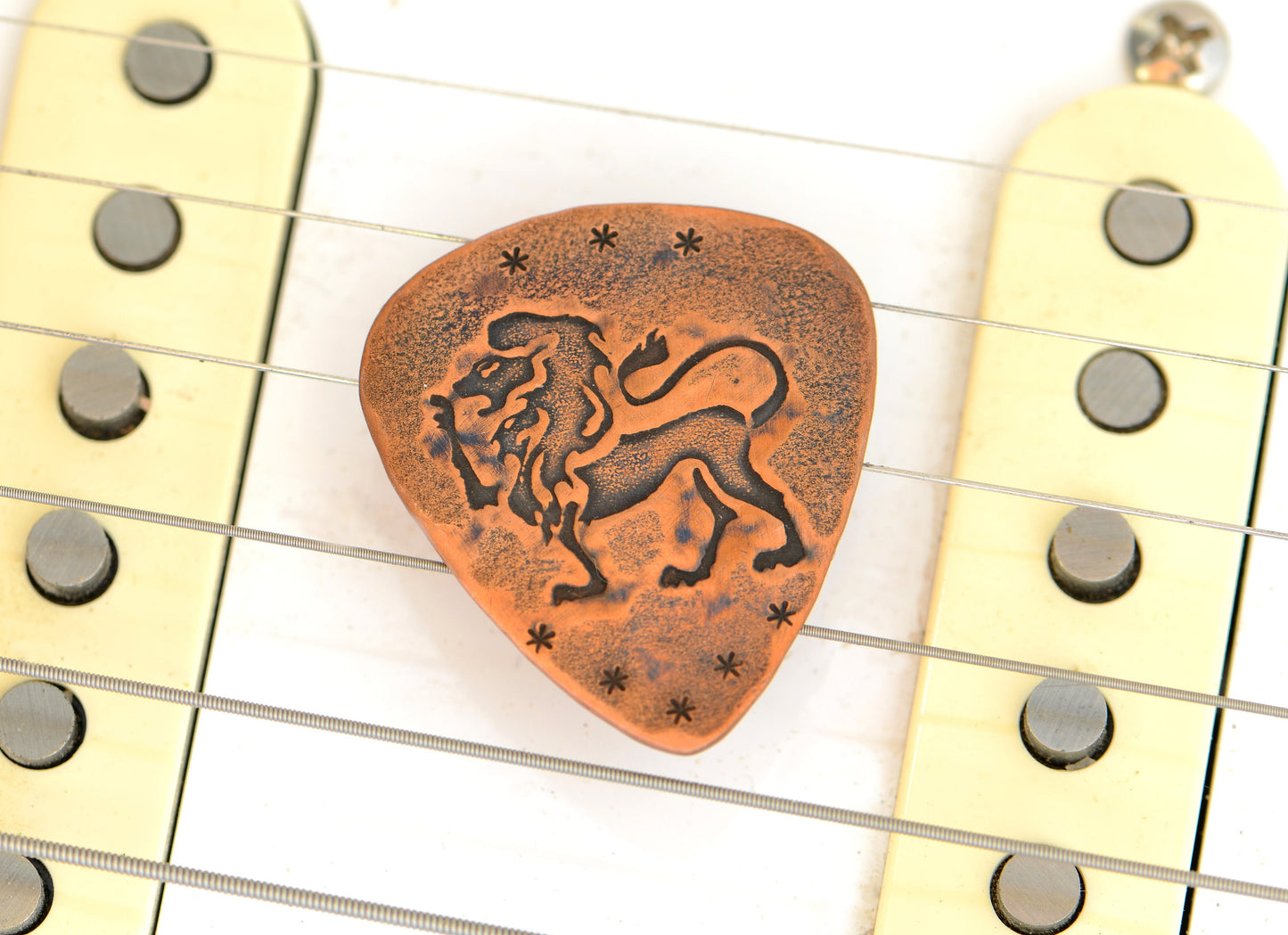 Lion on Guitar Pick in copper for extra roar