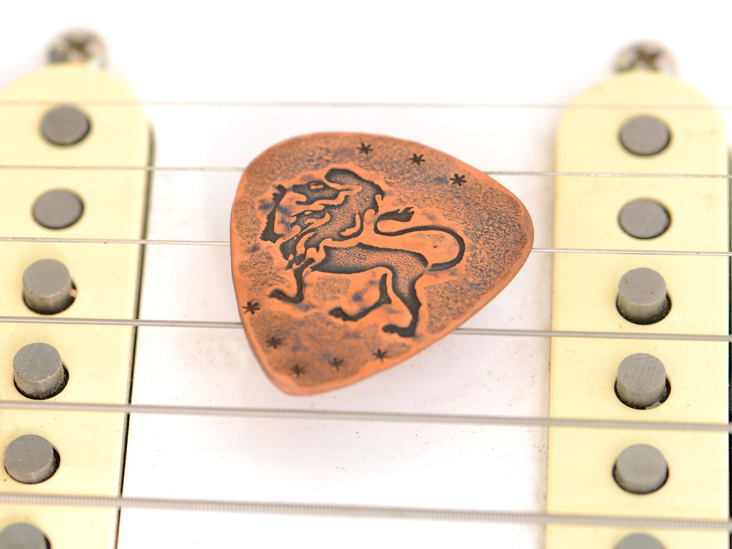 Lion on Guitar Pick in copper for extra roar