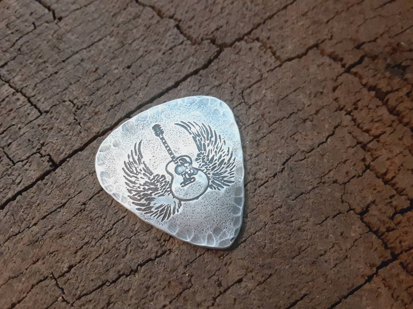 Winged guitar on hammered sterling silver guitar pick