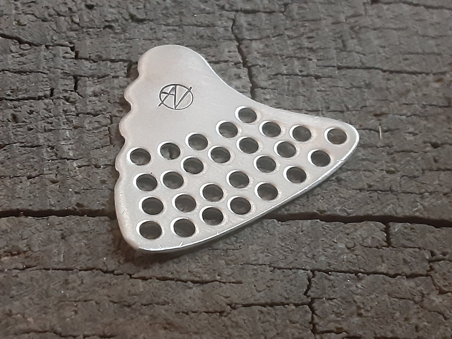 Shark tooth sterling silver guitar pick with hole punch outs