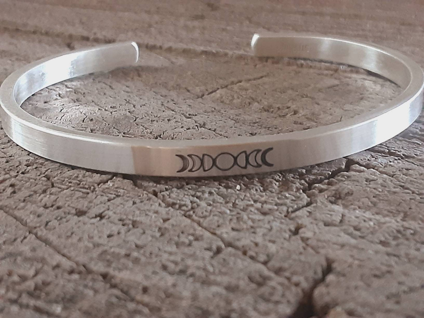 Celestial theme with moon phases on a cuff bracelet