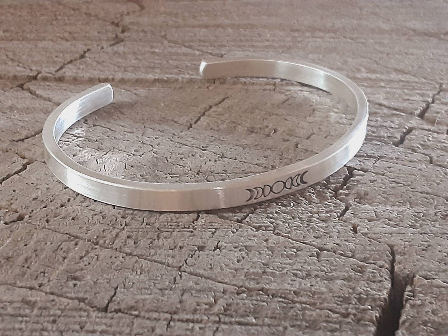 Celestial theme with moon phases on a cuff bracelet