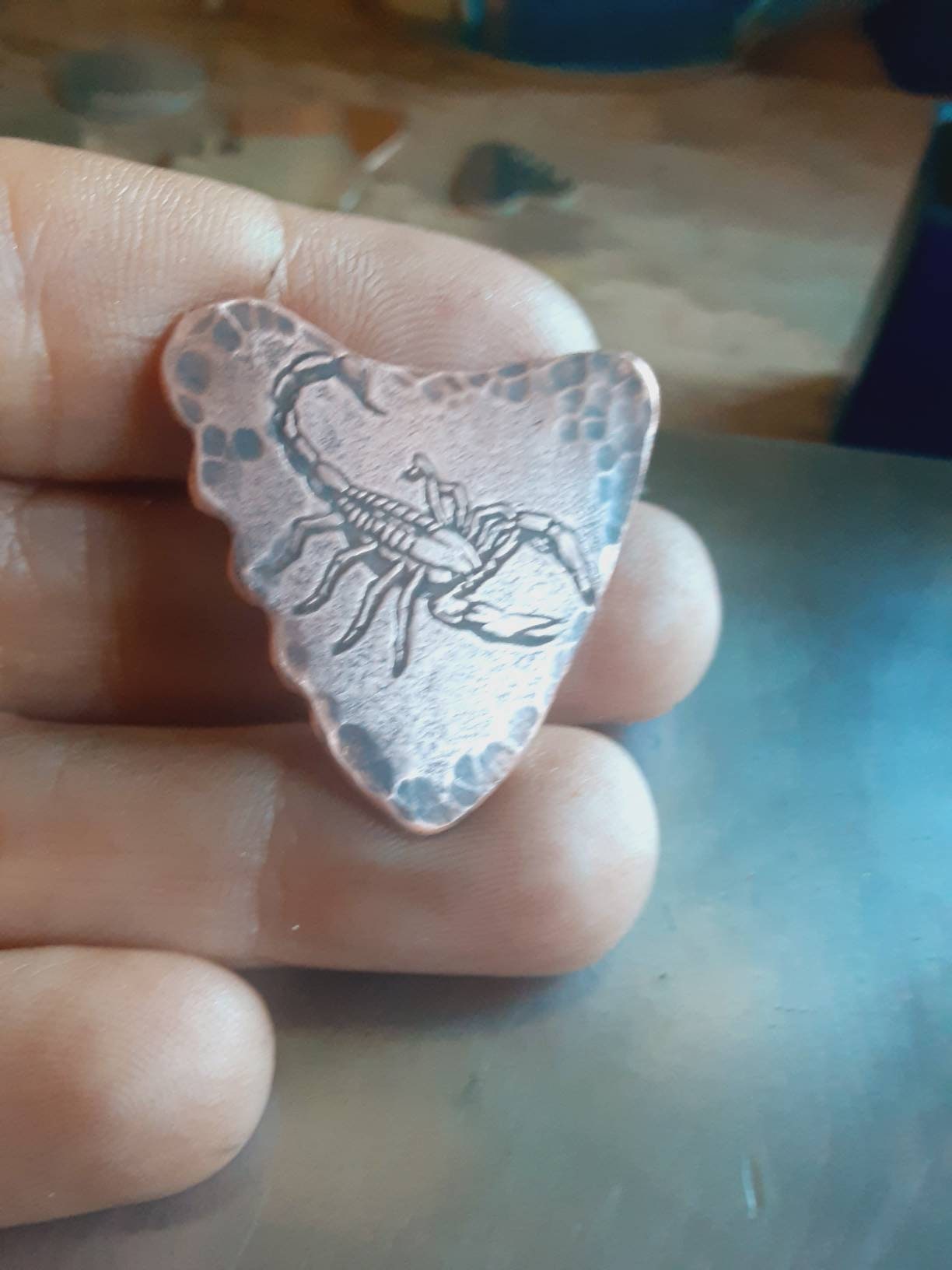 Copper shark tooth guitar pick with scorpion design