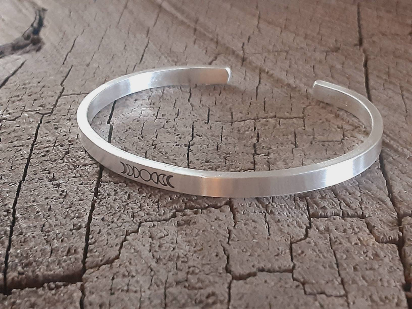 Celestial theme with moon phases on a cuff bracelet