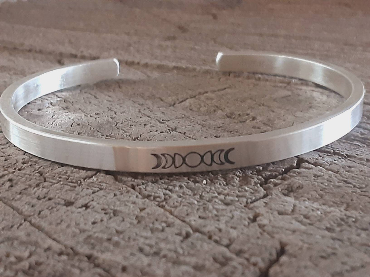 Celestial theme with moon phases on a cuff bracelet