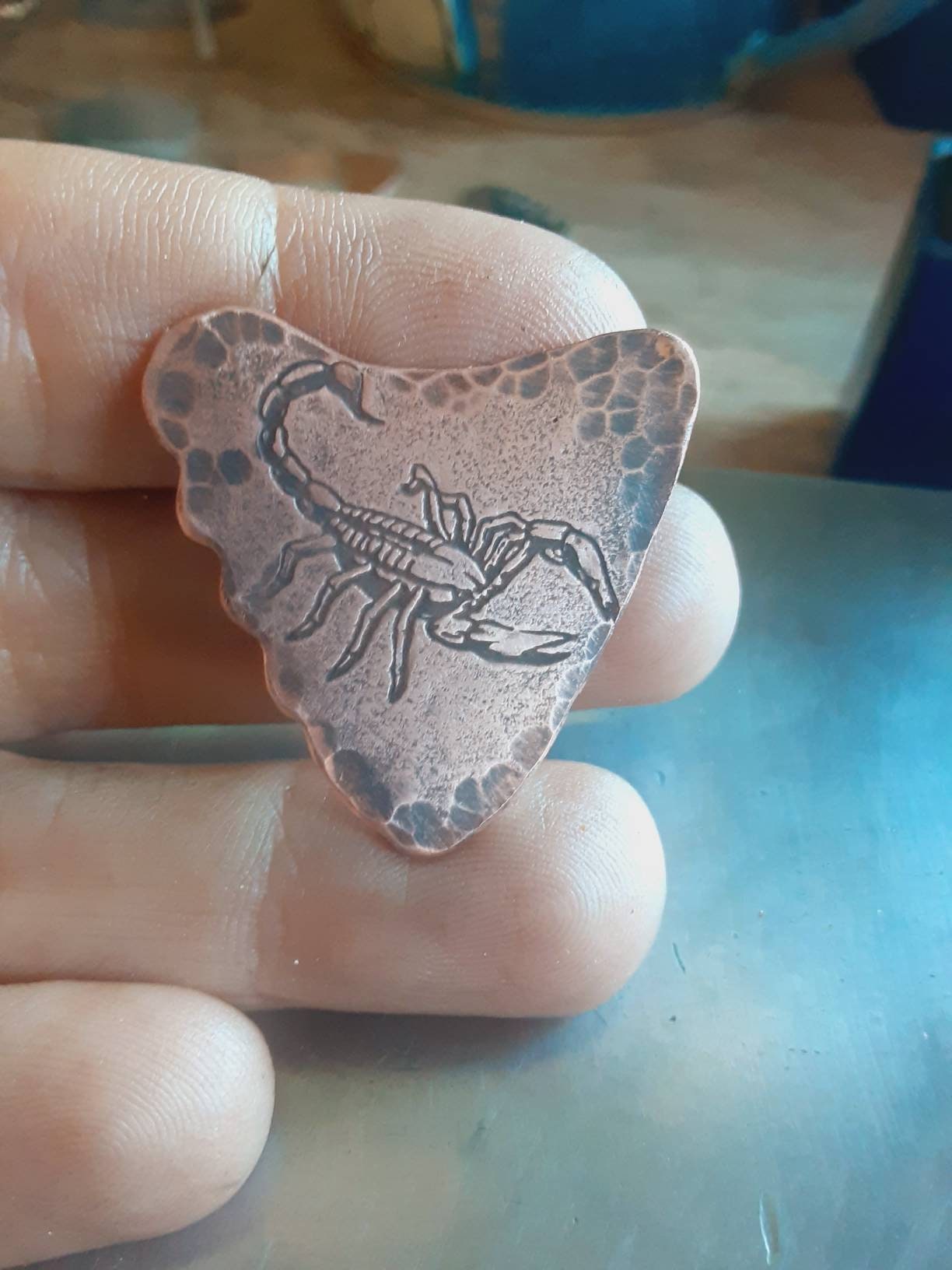 Copper shark tooth guitar pick with scorpion design