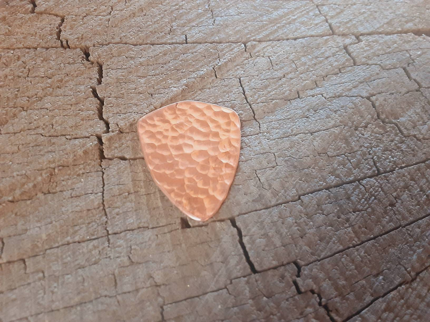 Guitar pick with paisley pattern in copper