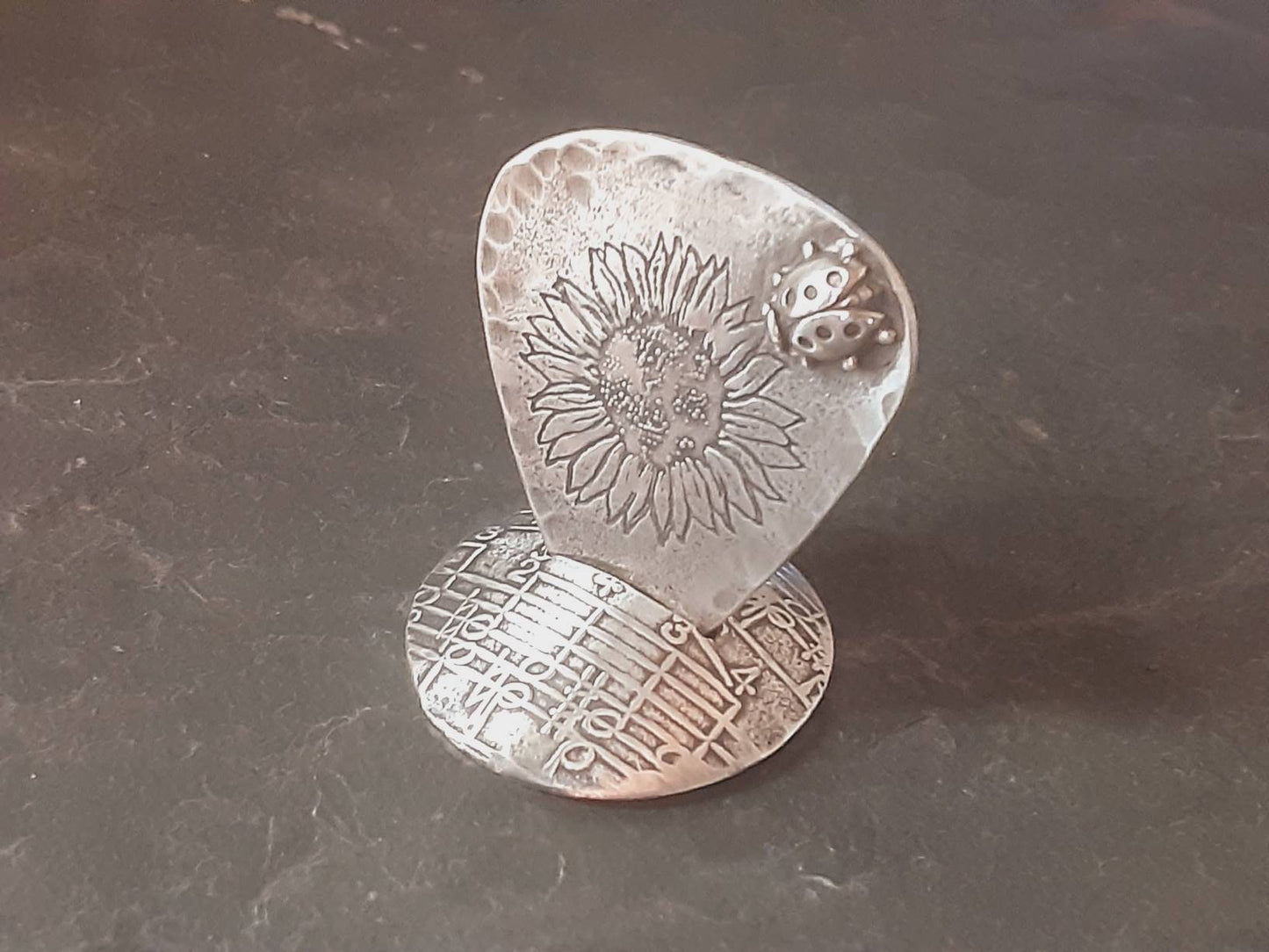 Guitar pick and stand combination in sterling silver with sunflower design and 3D soldered ladybug