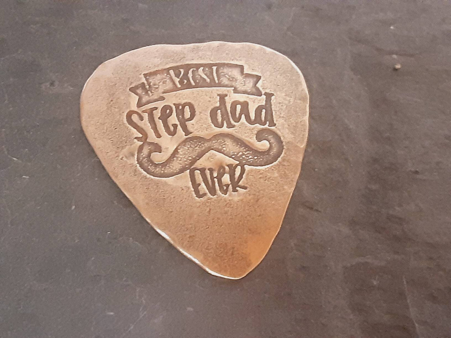 Bronze guitar pick with Best Stepdad Ever