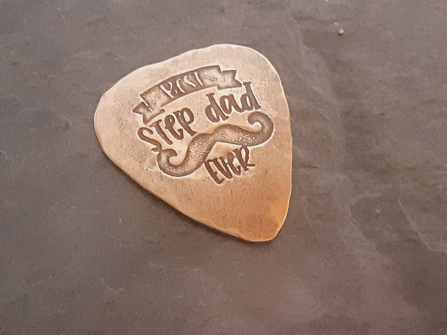 Bronze guitar pick with Best Stepdad Ever