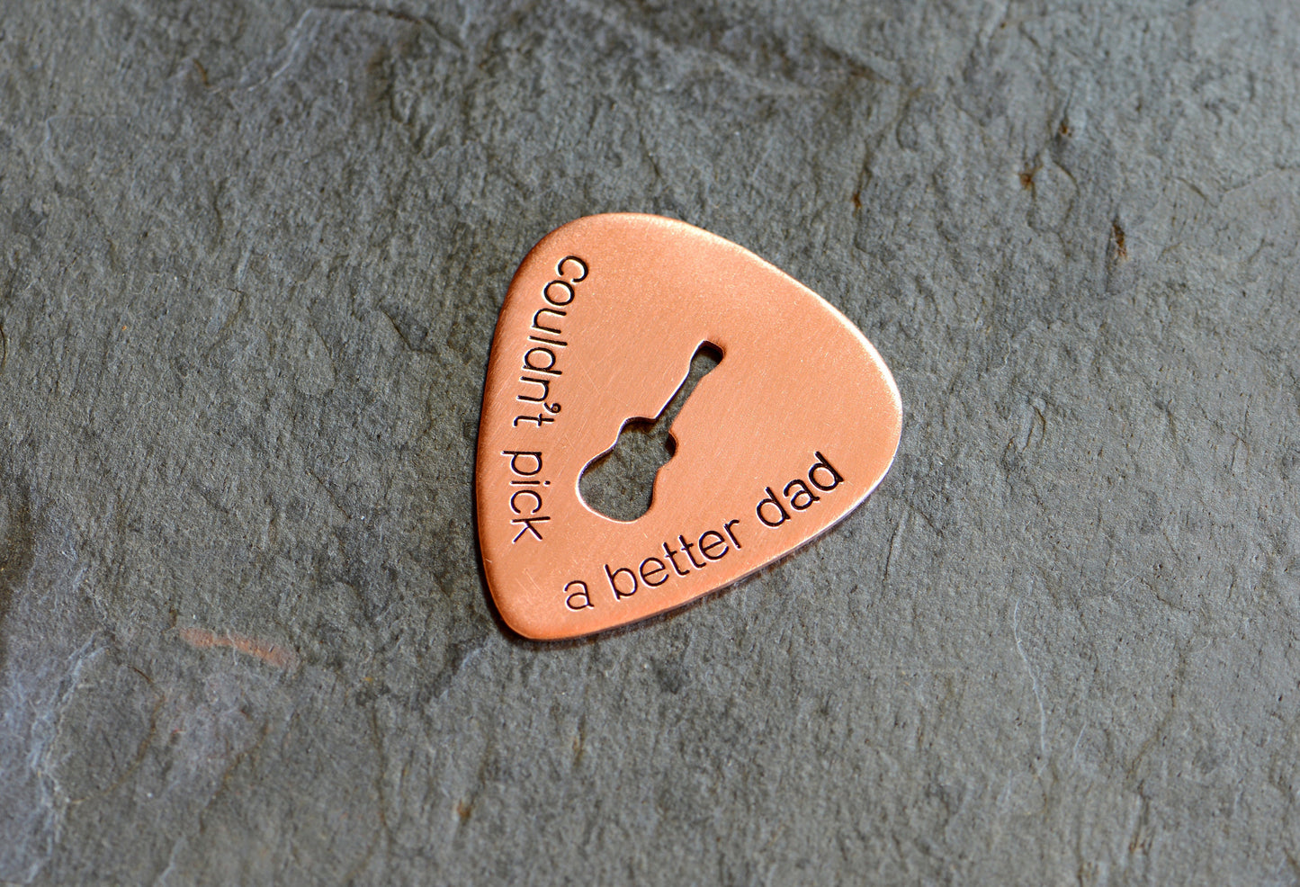 Guitar pick with Couldn't pick a better dad and a cutout guitar in bronze