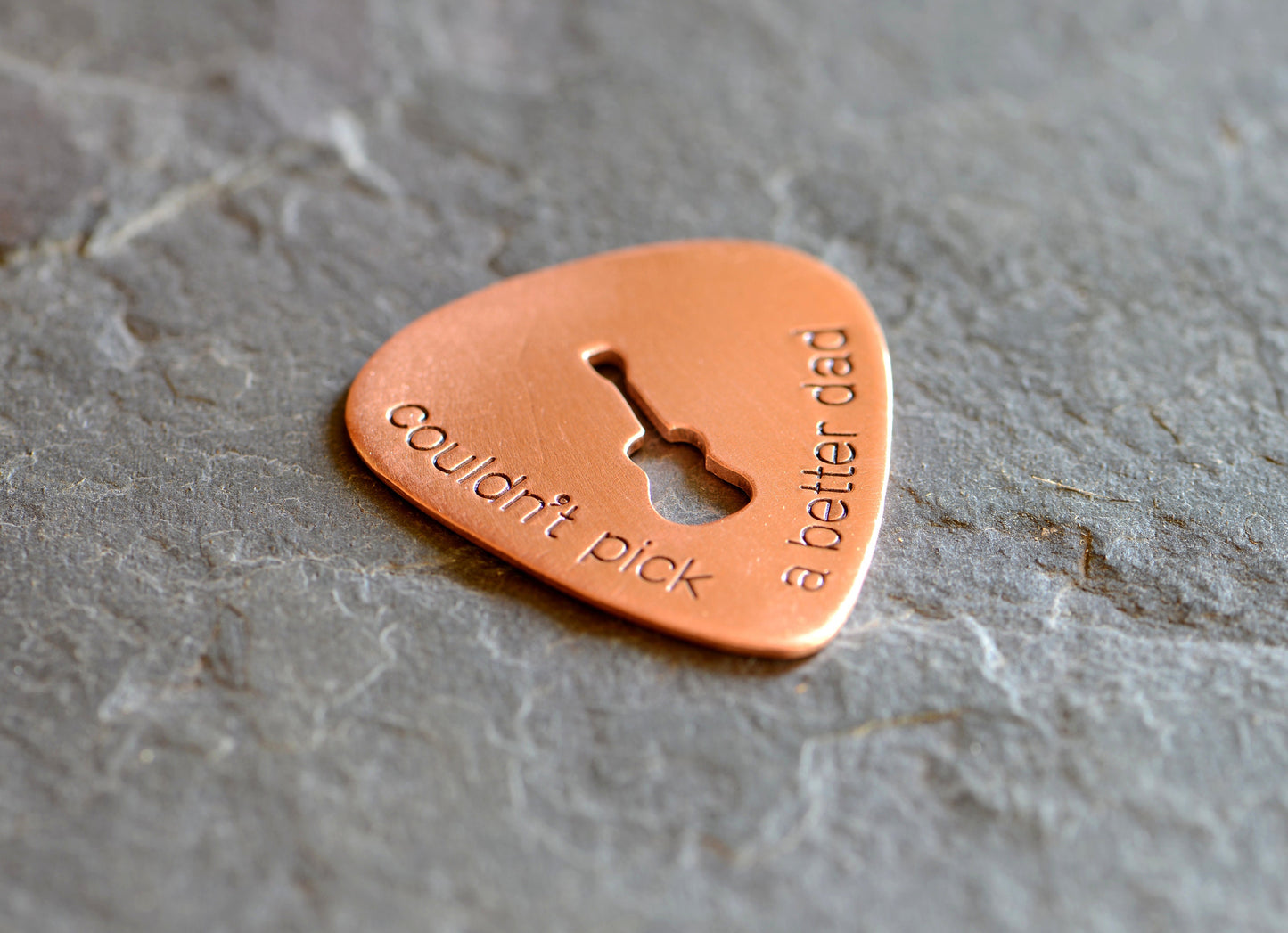 Guitar pick with Couldn't pick a better dad and a cutout guitar in bronze