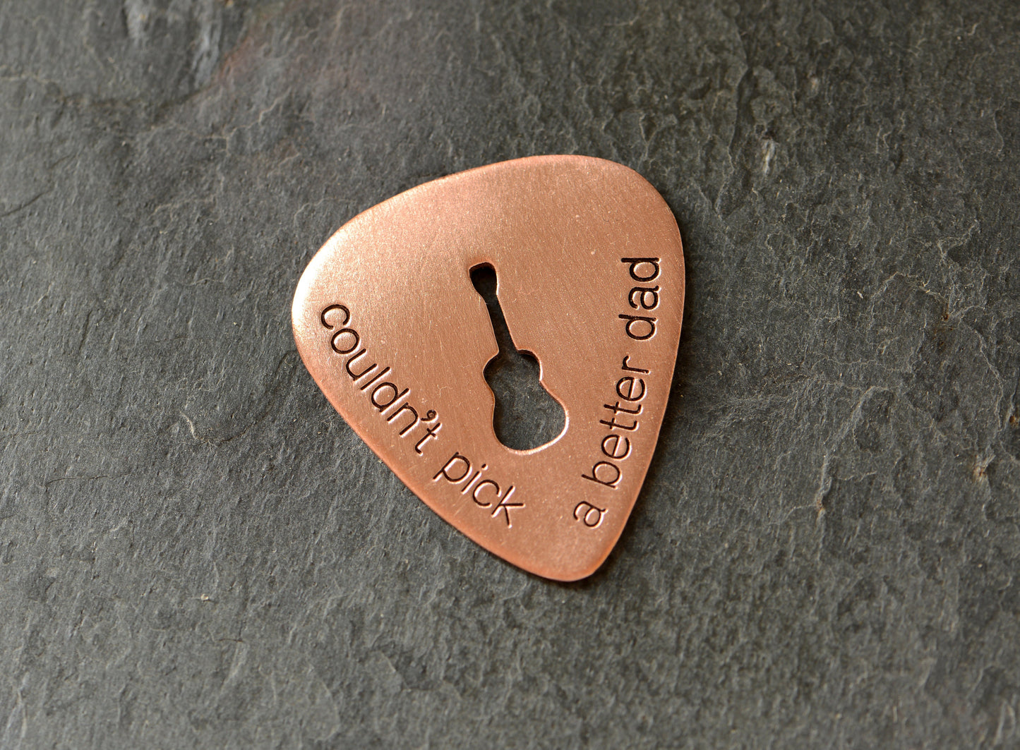 Guitar pick with Couldn't pick a better dad and a cutout guitar in bronze