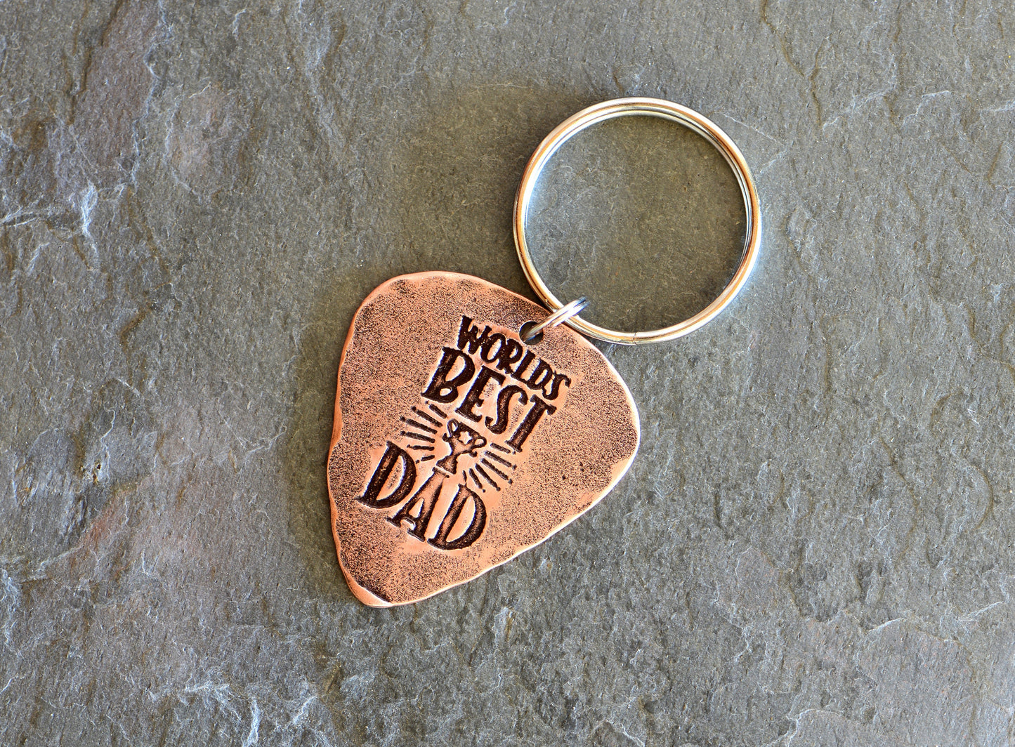 Worlds best dad stamped on a copper guitar pick keychain