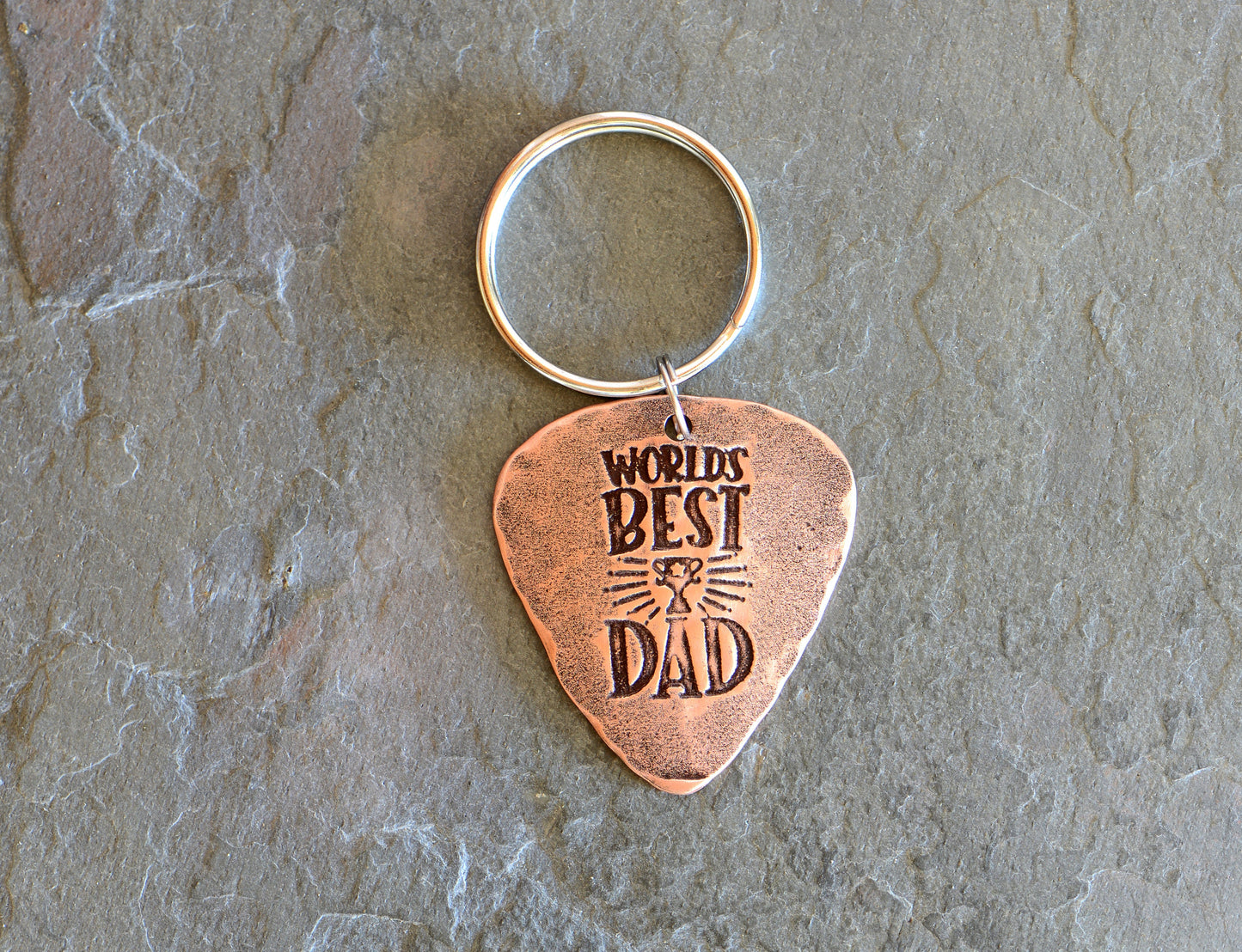 Worlds best dad stamped on a copper guitar pick keychain