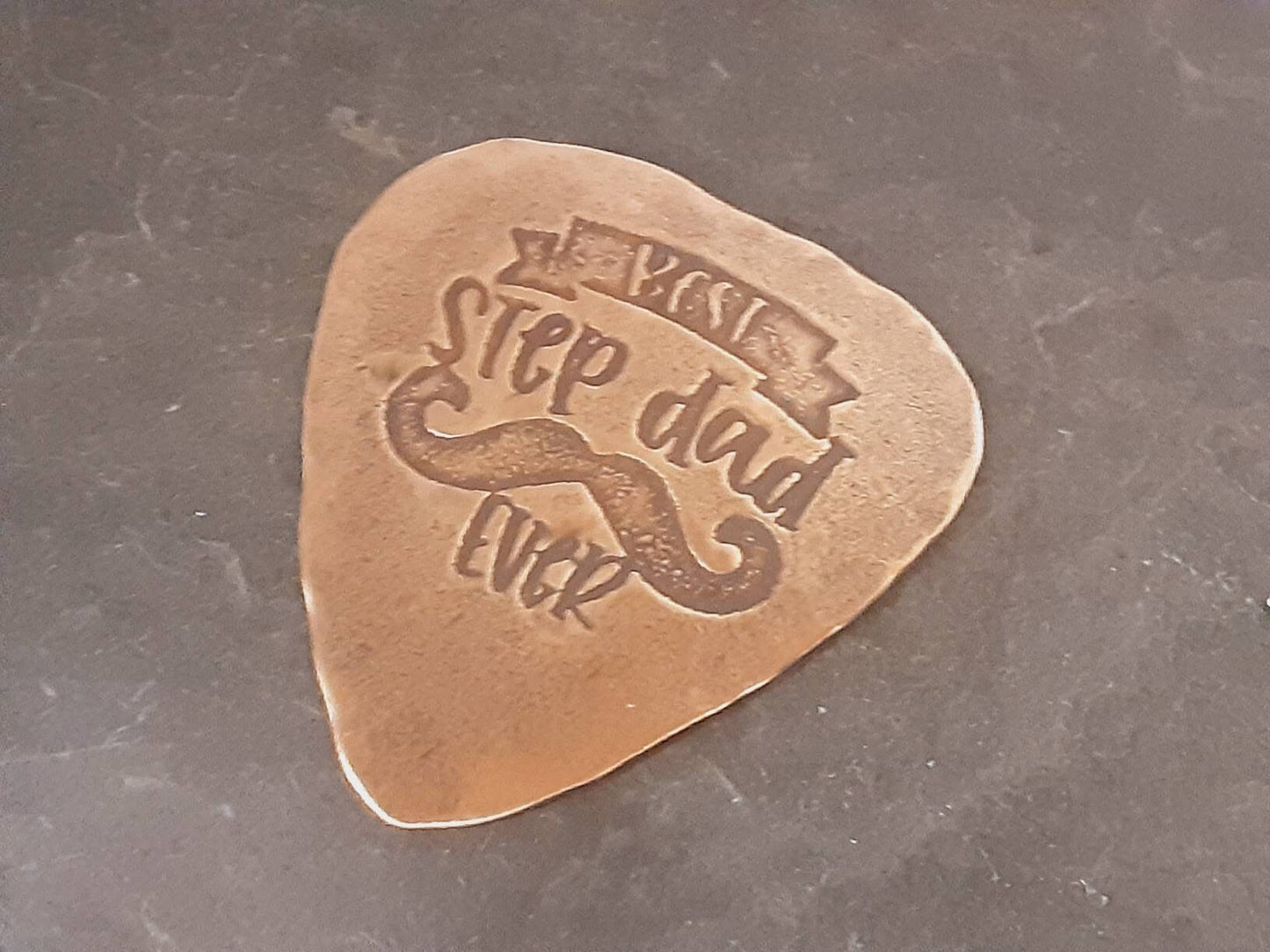 Bronze guitar pick with Best Stepdad Ever