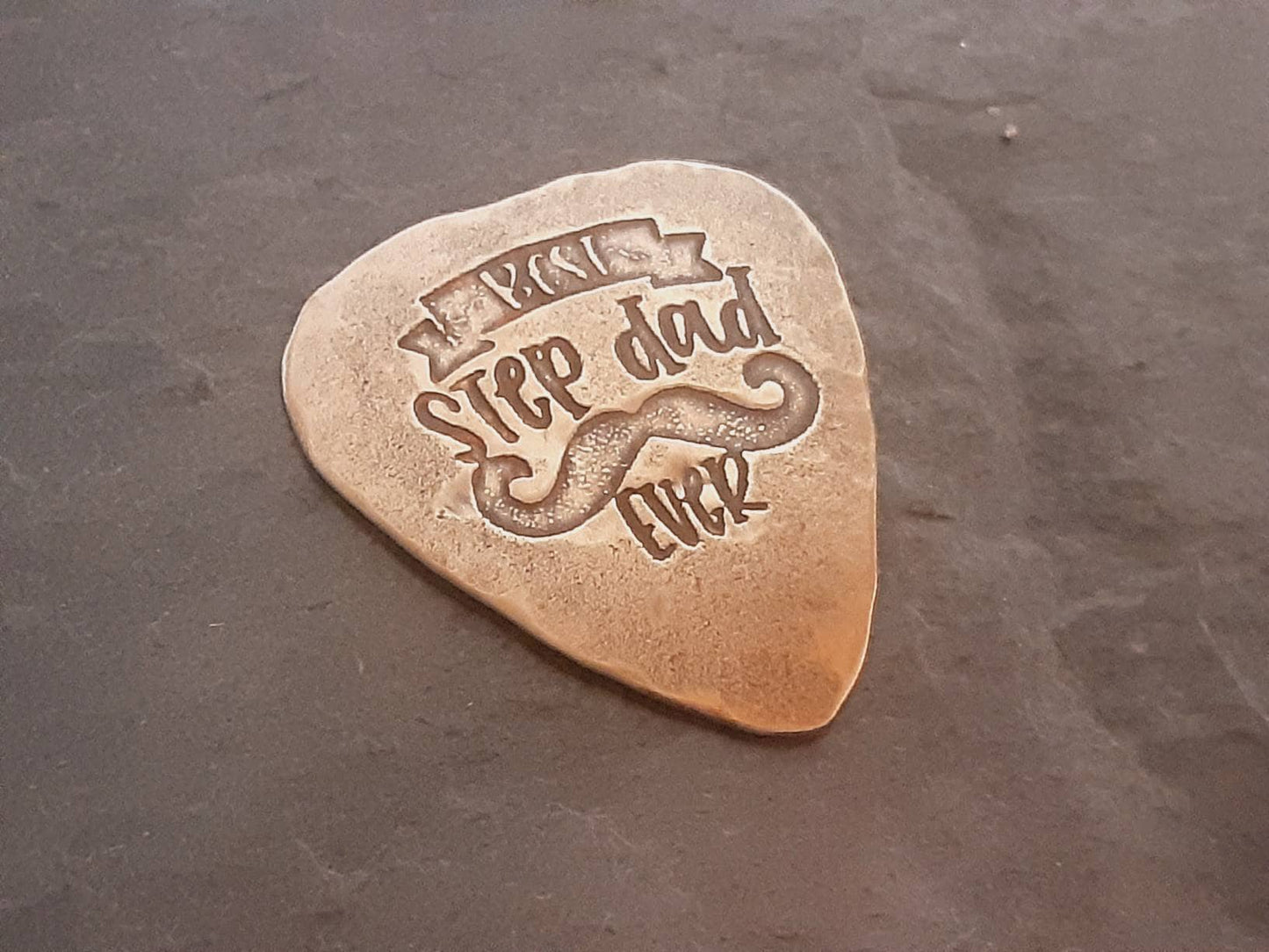 Bronze guitar pick with Best Stepdad Ever