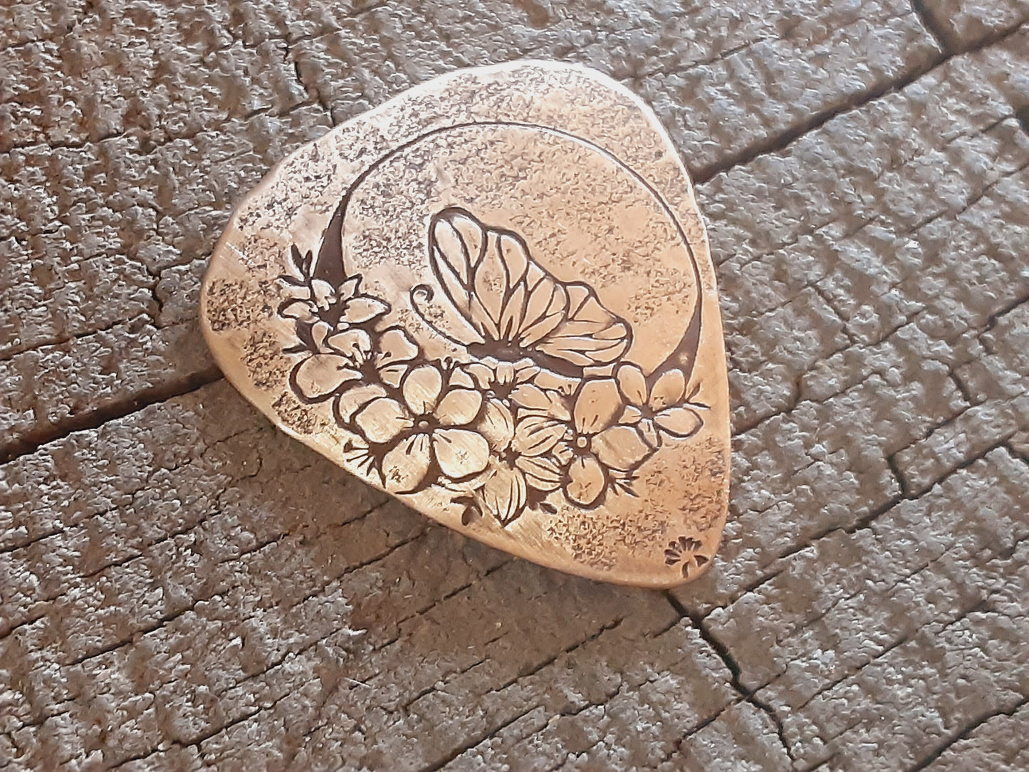 Bronze guitar pick with butterfly