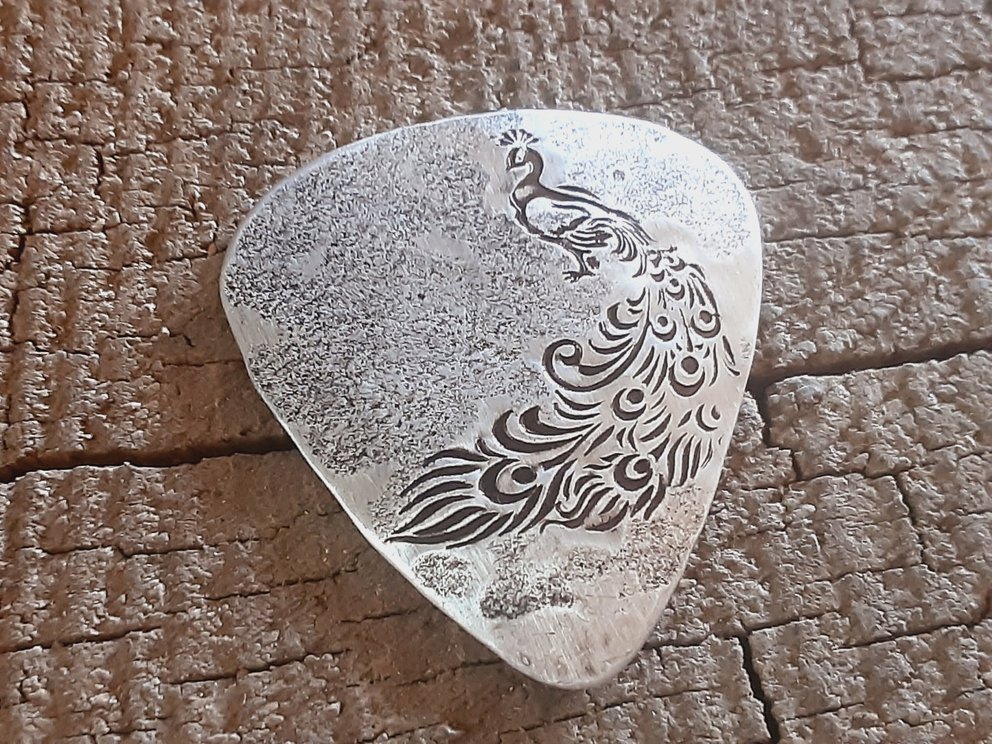 Sterling silver guitar pick with peacock