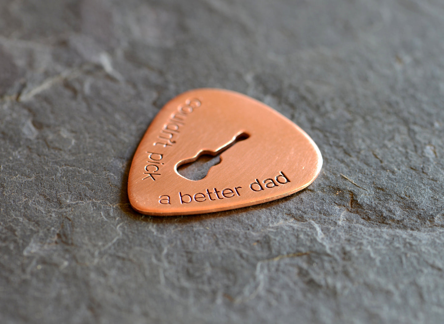 Guitar pick with Couldn't pick a better dad and a cutout guitar in bronze
