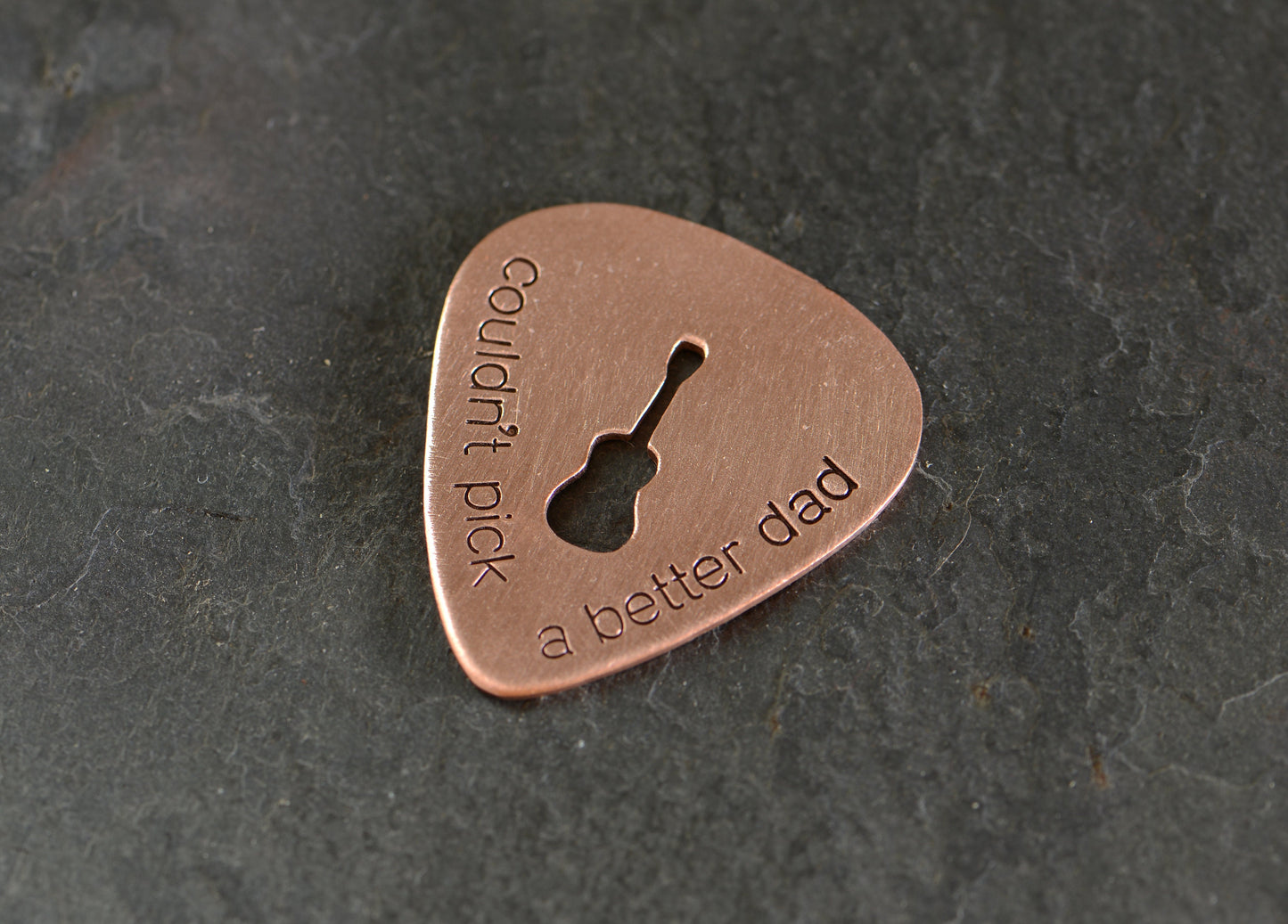Guitar pick with Couldn't pick a better dad and a cutout guitar in bronze