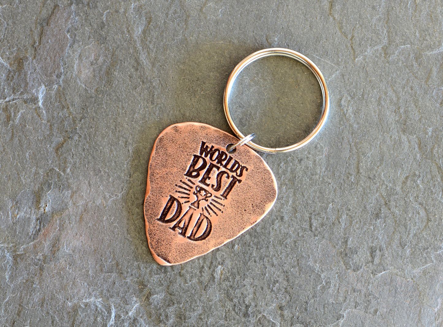 Worlds best dad stamped on a copper guitar pick keychain