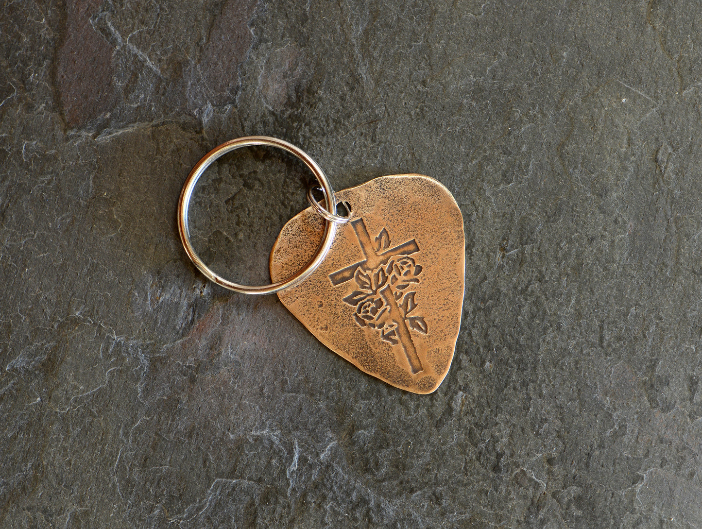 Roses and cross design on bronze guitar pick keychain