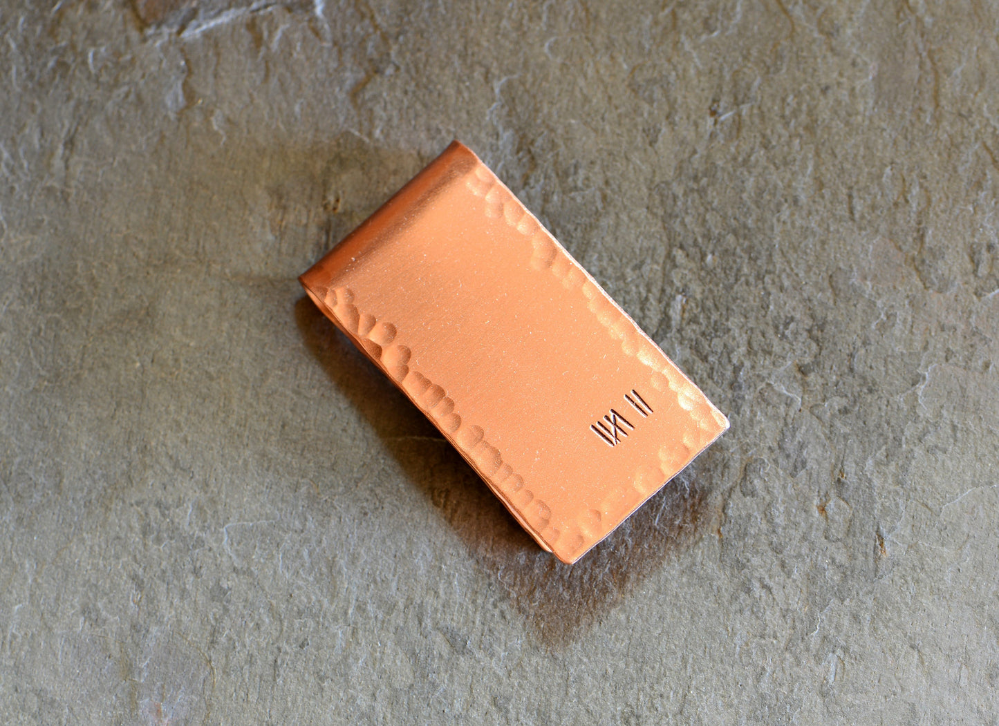 Copper money clip for the 7th anniversary with 7 tally marks to keep track