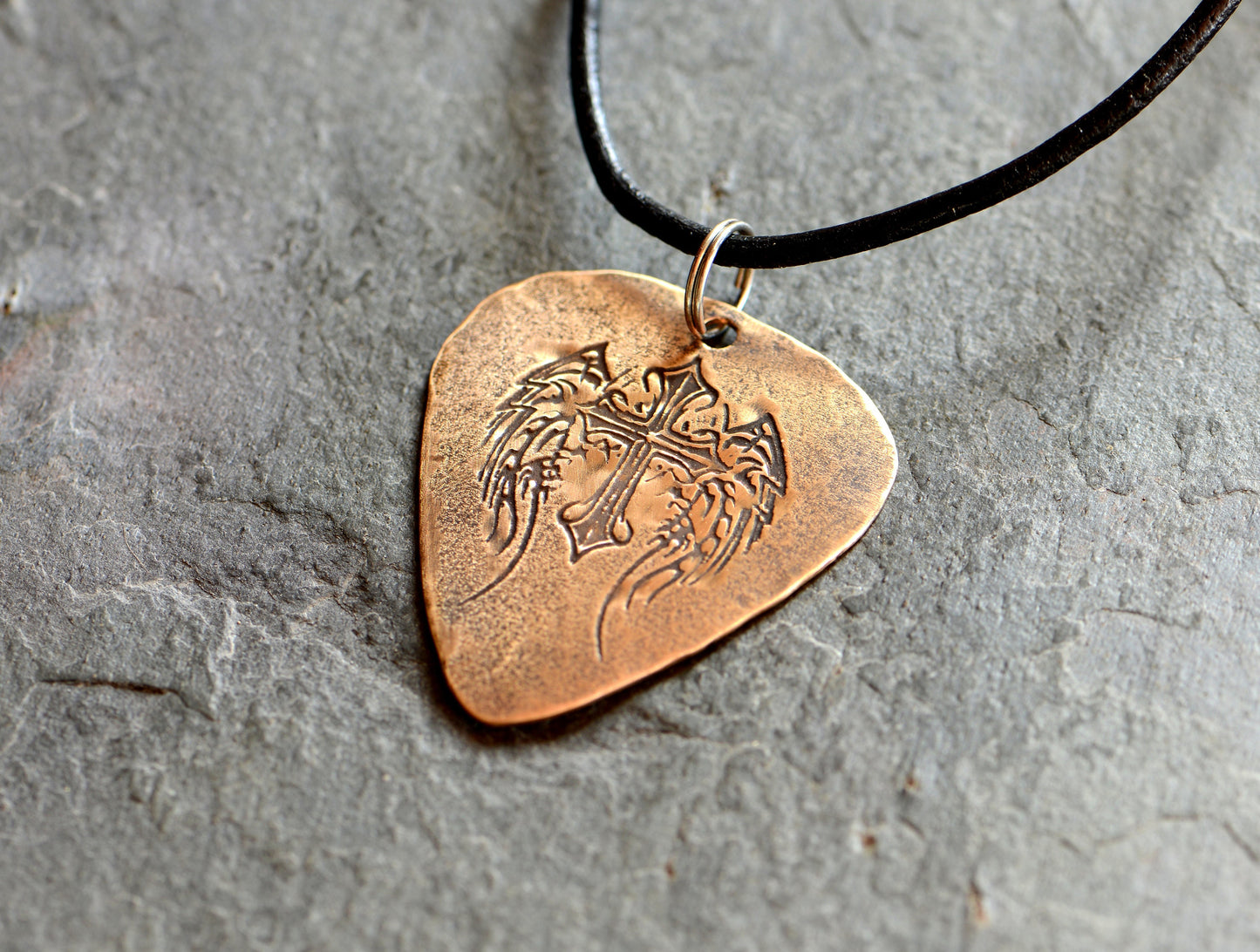 Winged cross on bronze guitar pick transformed into a necklace