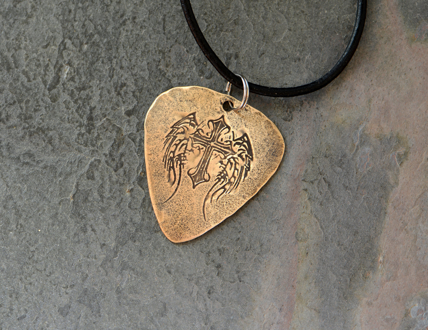 Winged cross on bronze guitar pick transformed into a necklace