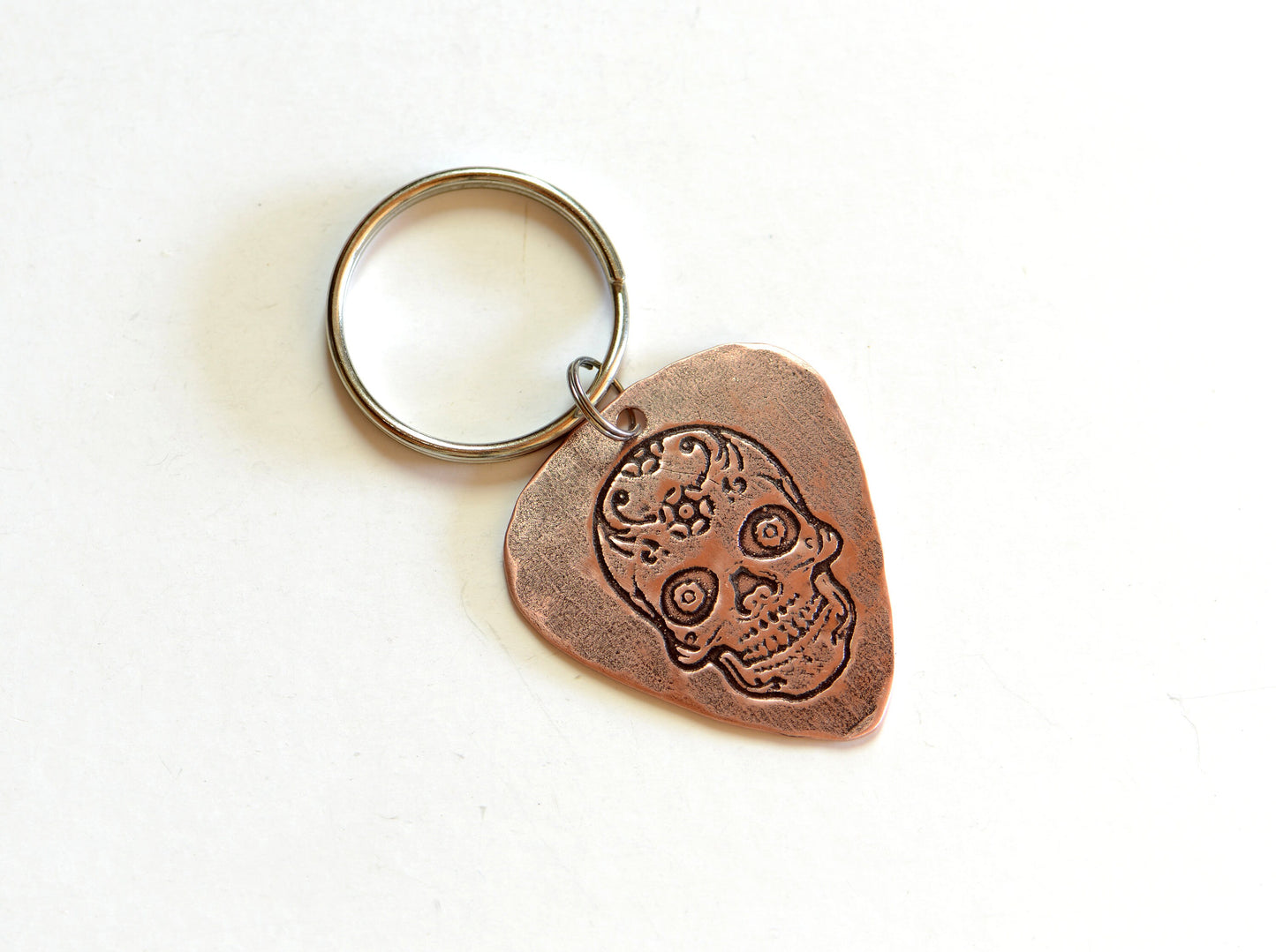 Copper guitar pick key chain with sugar skull