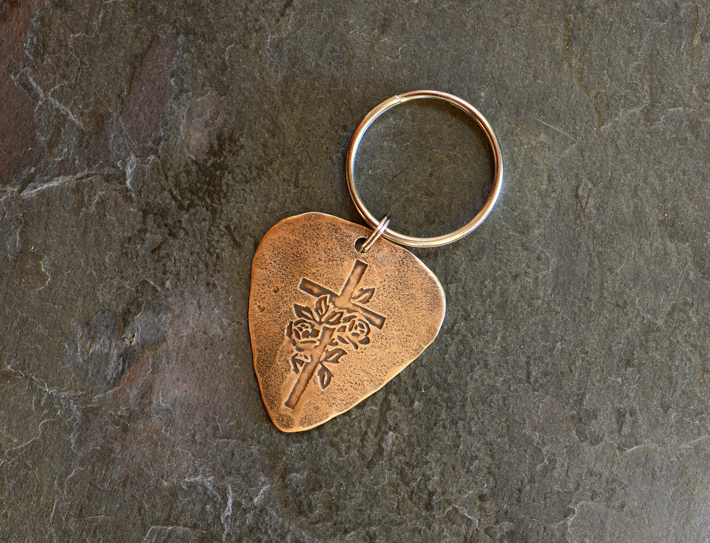 Roses and cross design on bronze guitar pick keychain