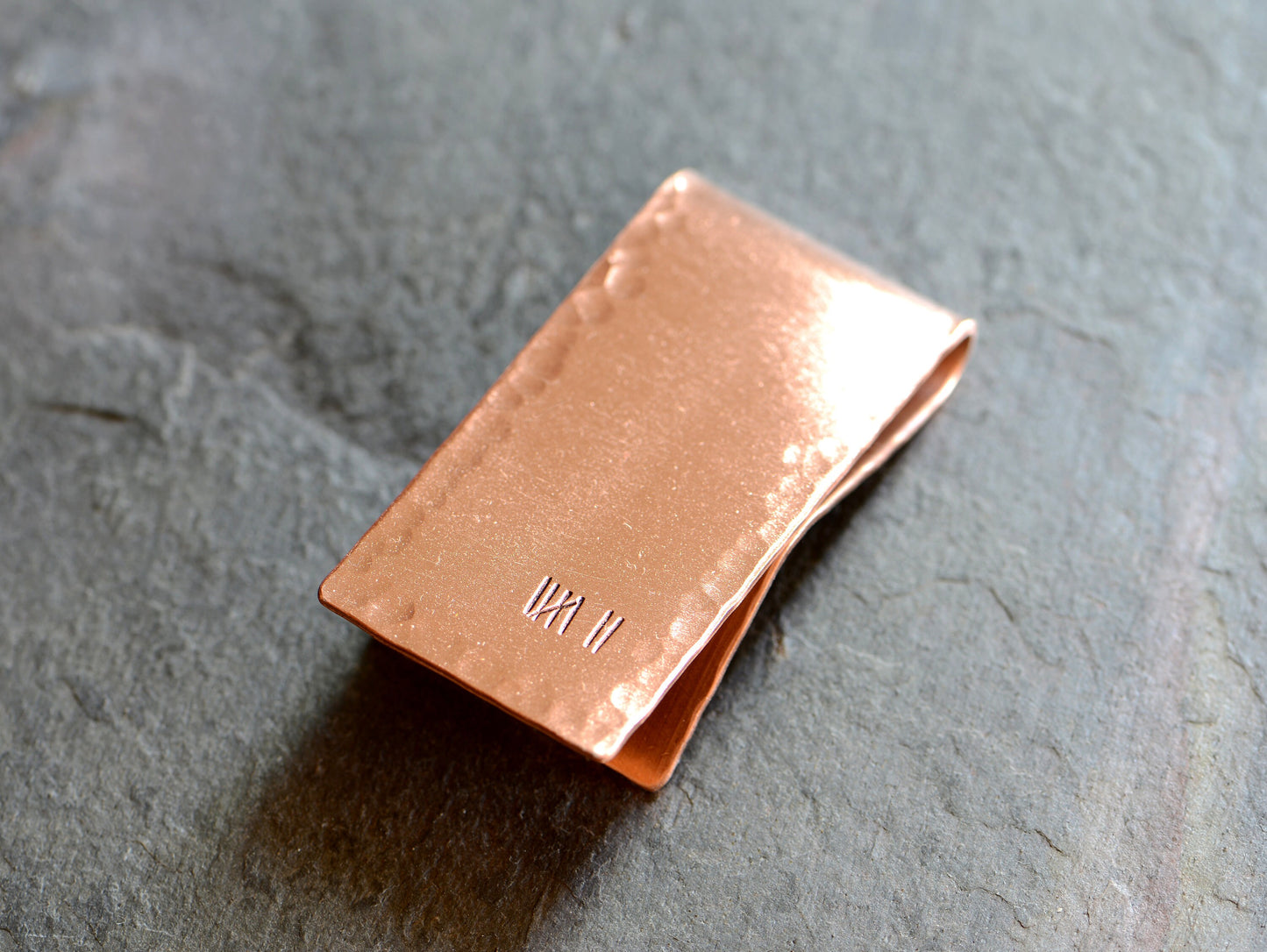 Copper money clip for the 7th anniversary with 7 tally marks to keep track