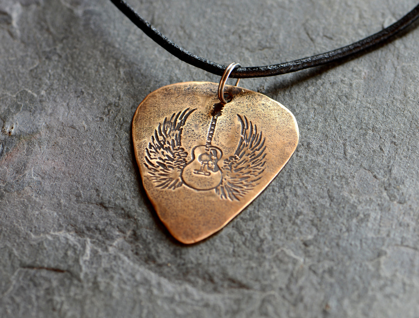 Winged guitar on bronze guitar pick necklace