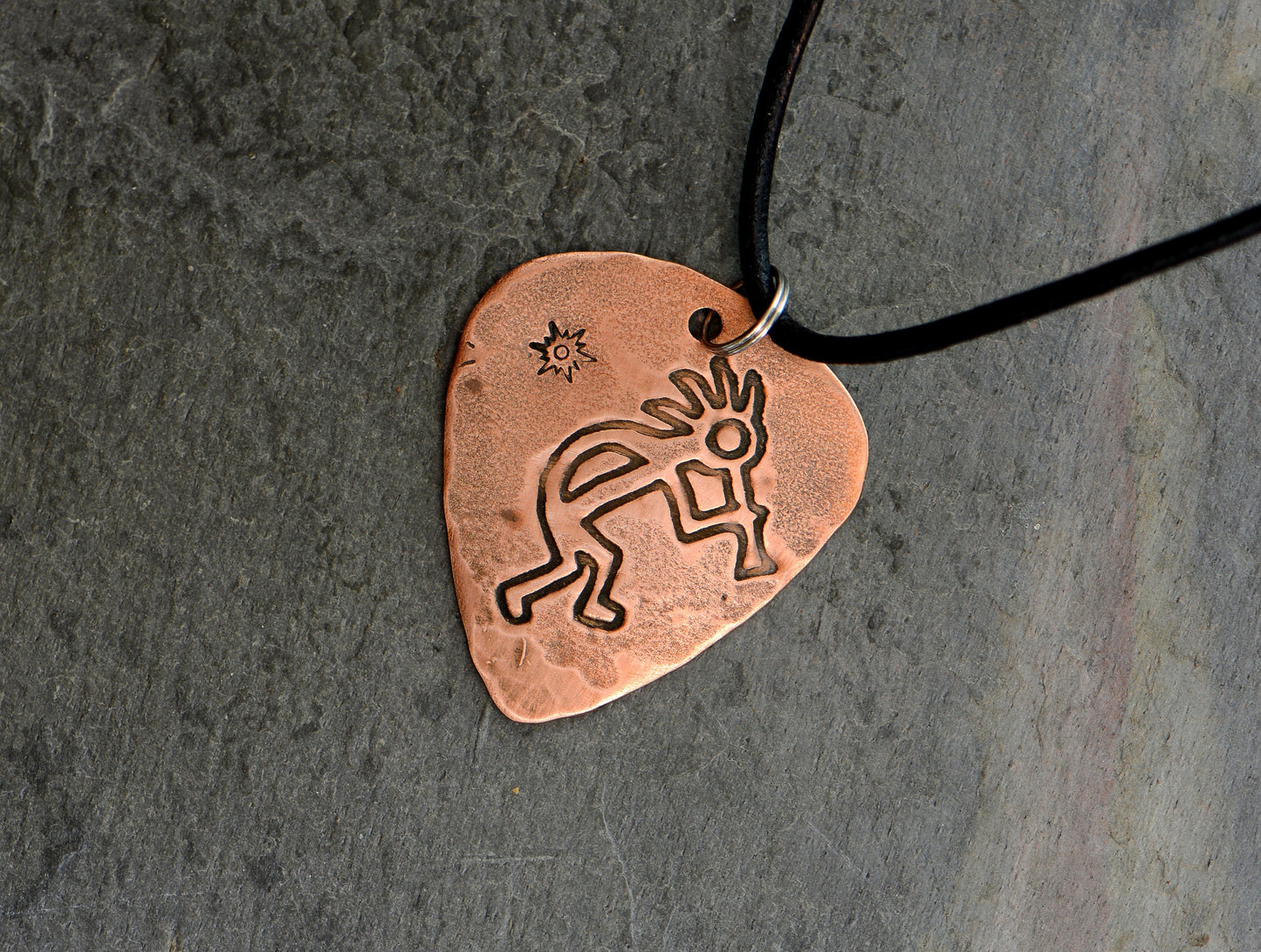 Kokopelli themed copper guitar pick necklace