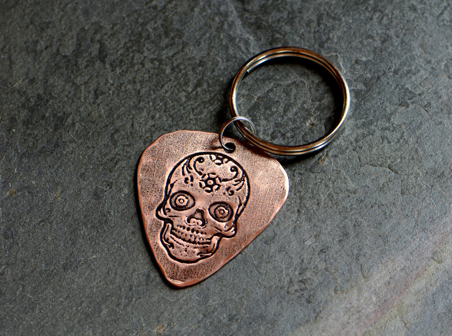 Copper guitar pick key chain with sugar skull