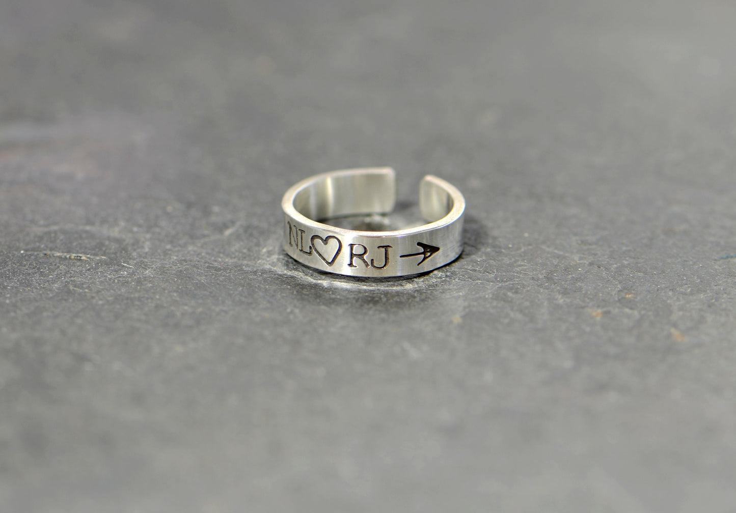 Sterling silver customized toe ring with initials framed by arrow