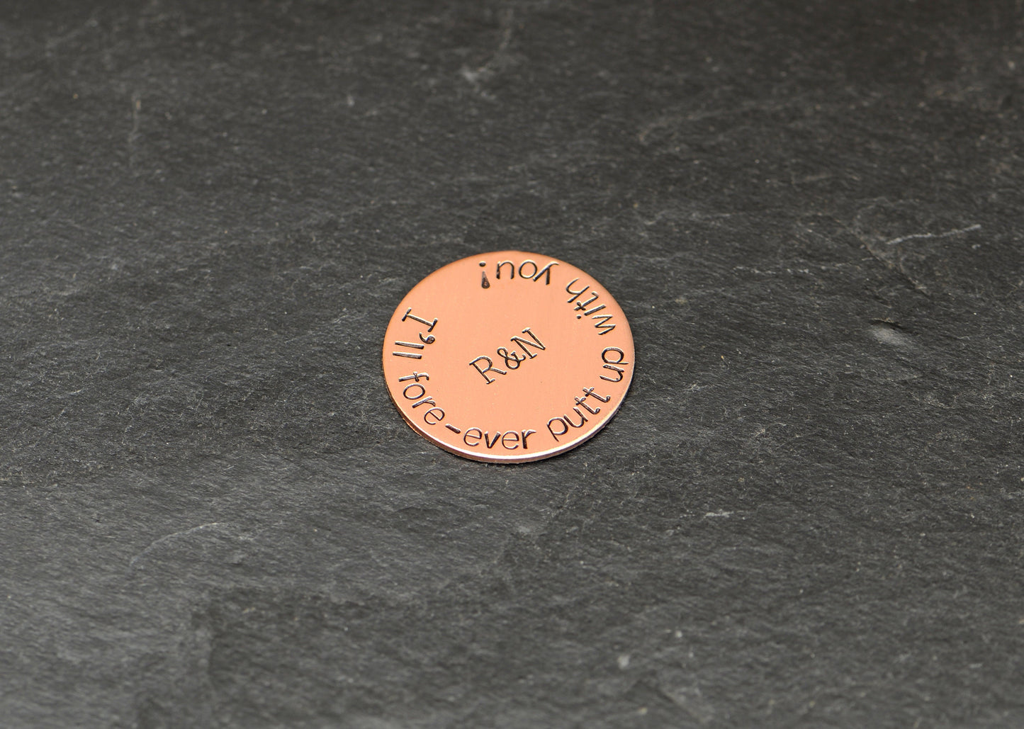 Initials on copper golf ball marker