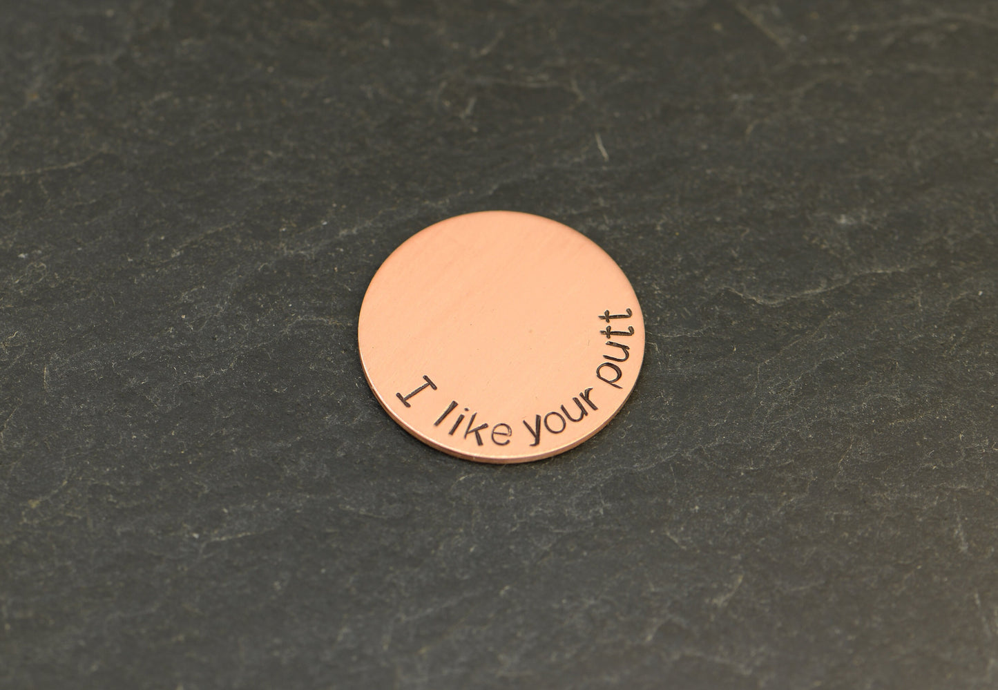 Copper golf ball marker with I like your putt