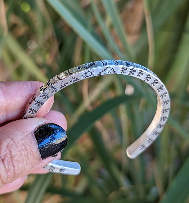 Square sterling silver wire cuff bracelet with Thunderbird patterning on 3 sides