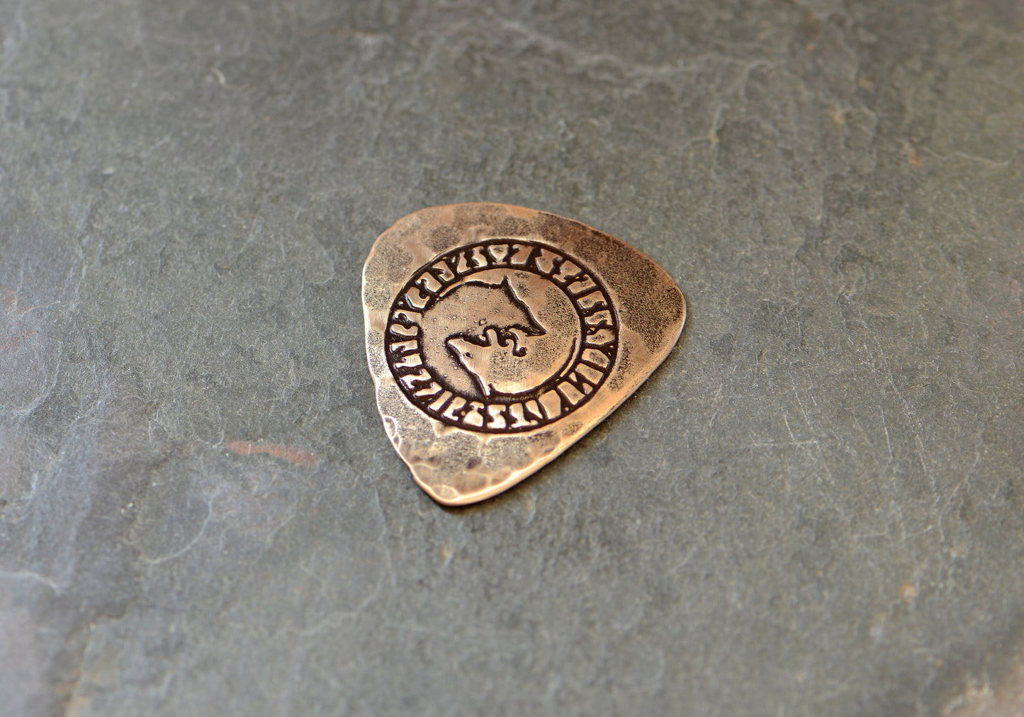 Bronze guitar pick with 2 wolves designs