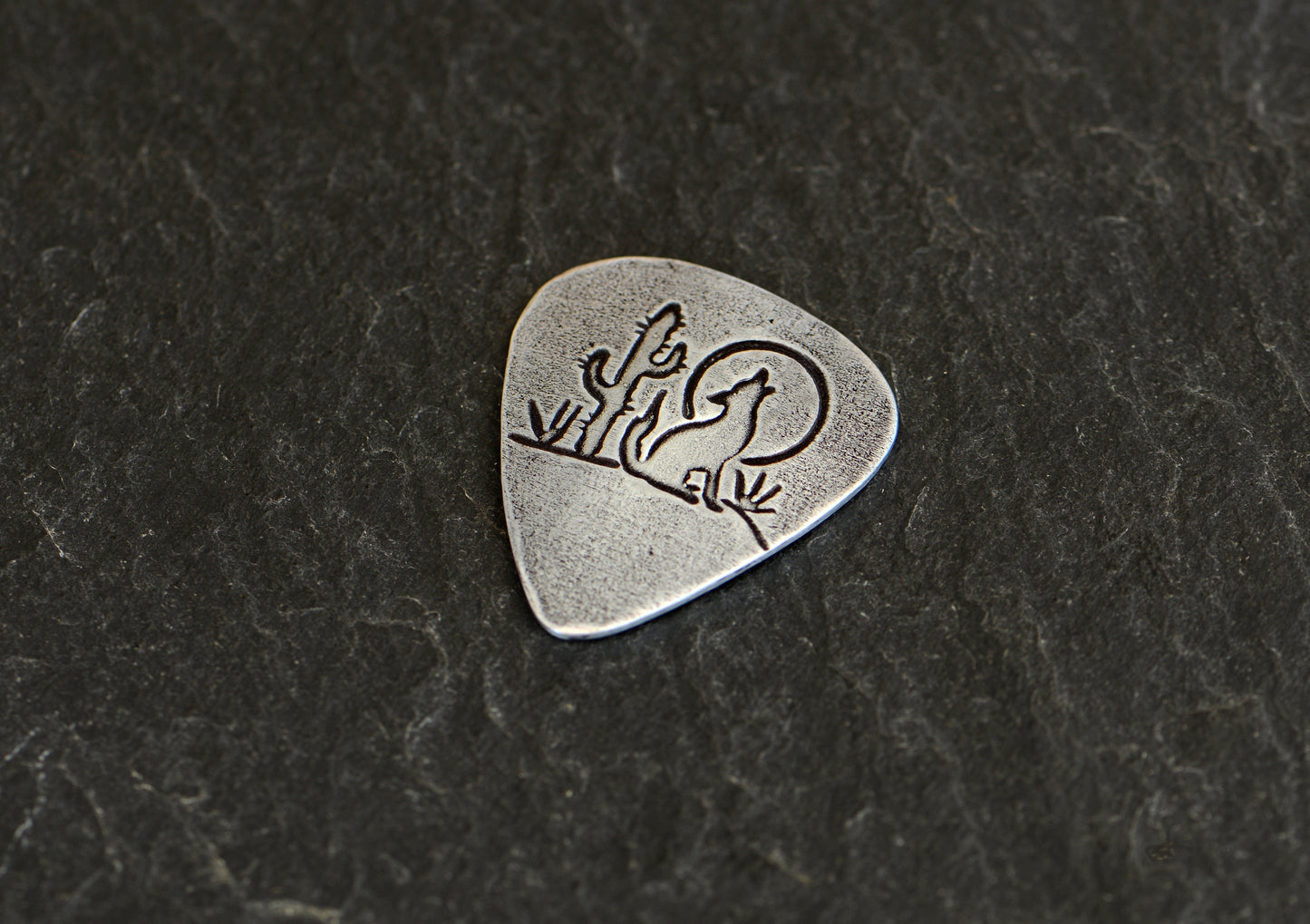 Desert theme sterling silver guitar pick with moon, howling wolf and cactus
