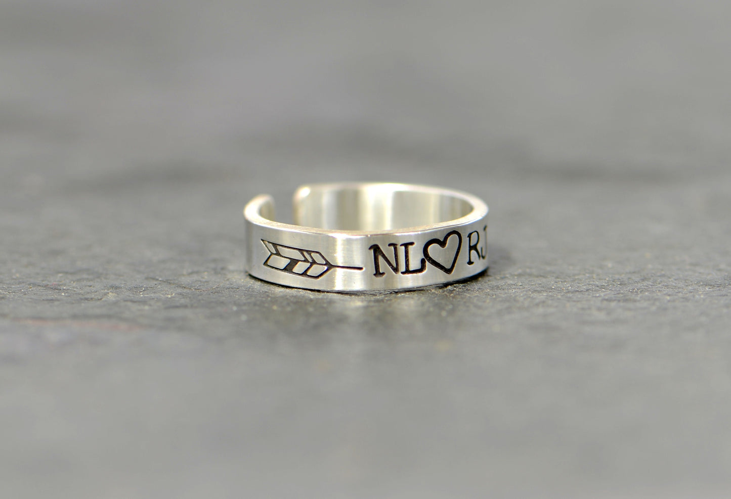 Sterling silver customized toe ring with initials framed by arrow