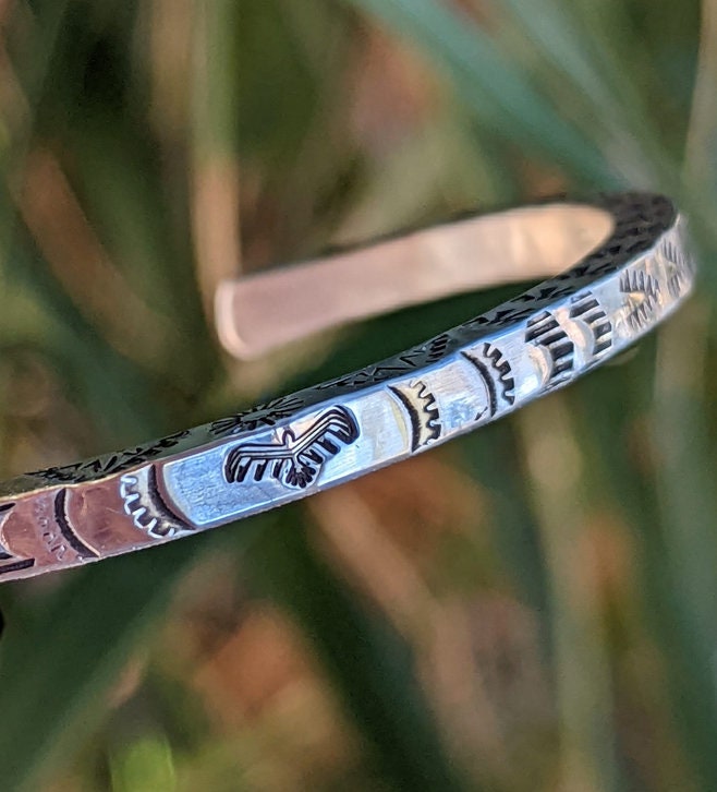 Square sterling silver wire cuff bracelet with Thunderbird patterning on 3 sides