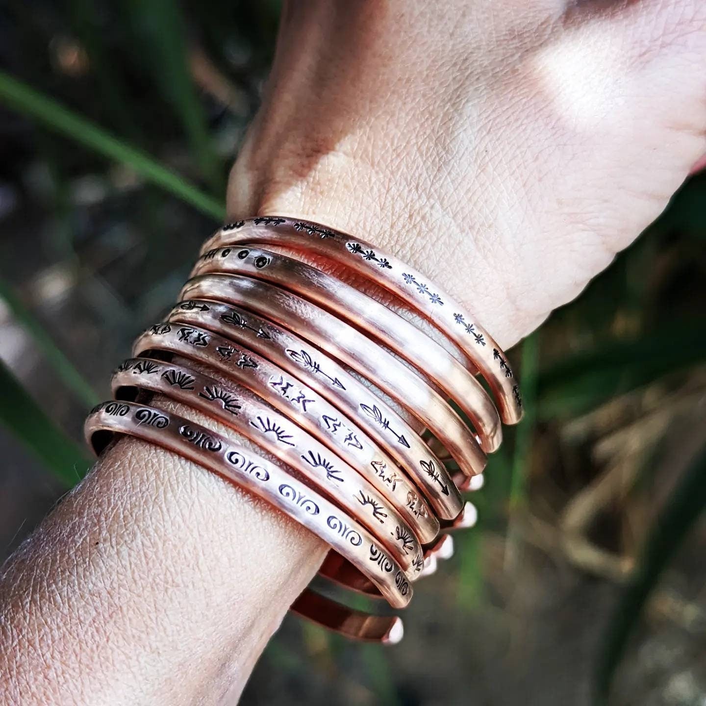 Copper cuff bracelets with stars and Thunderbird arrows